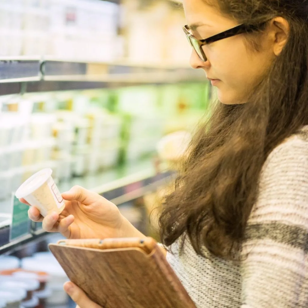 Student checking price of goods at the supermarket
