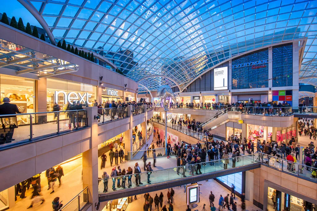 Trinity Shopping Centre in Leeds, interior shot on a busy day with lots of visitors walking past.