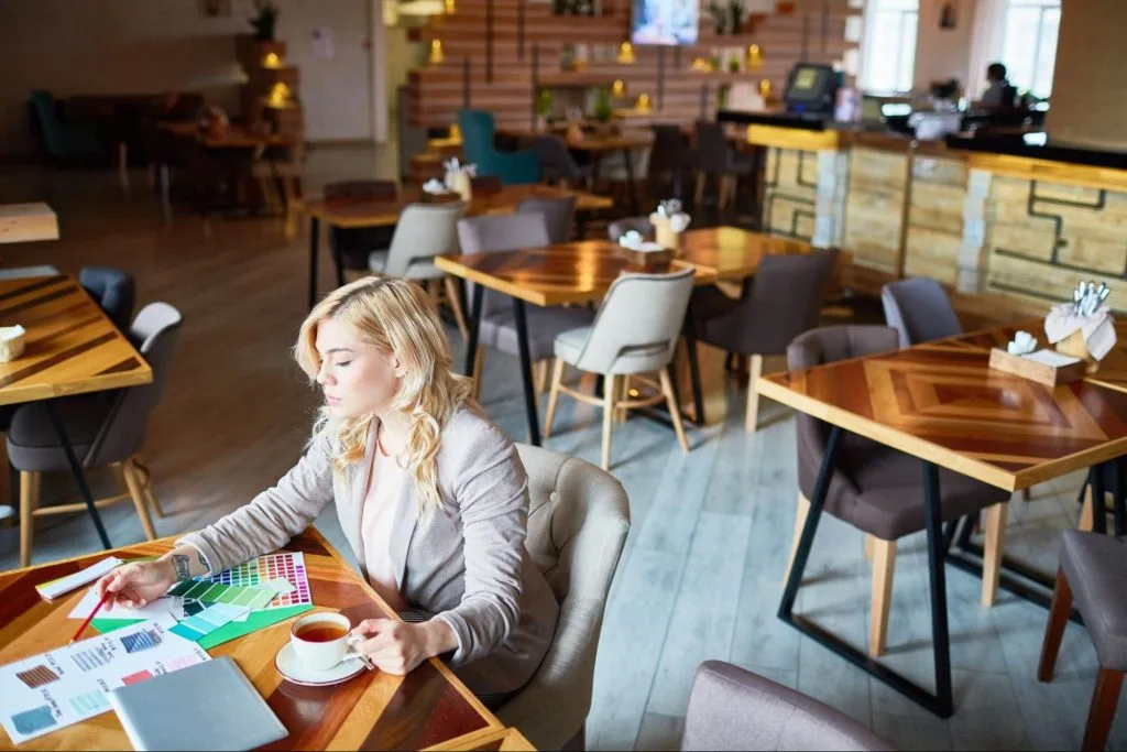  Students working on devices over tea and snacks in one of Loughborough’s popular cafés, showcasing a social yet study-friendly environment
