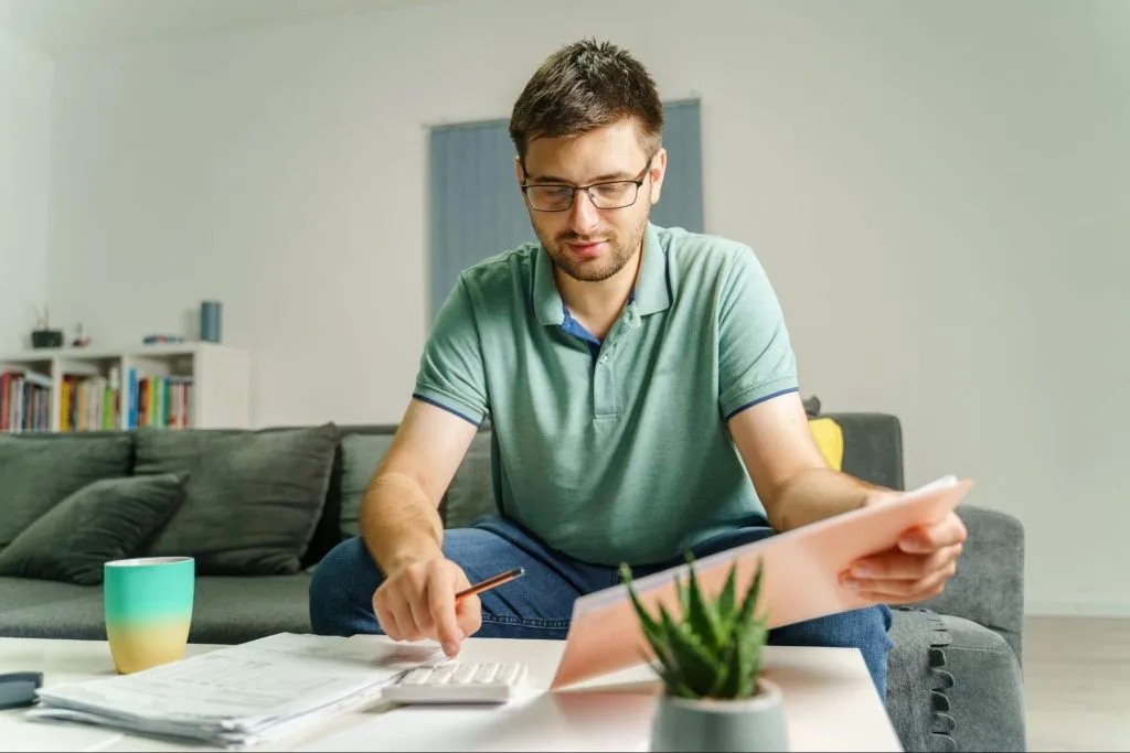  Student calculating monthly living expenses, showcasing smart financial planning practices for affordable living in Bristol