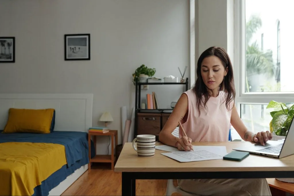 Student studying in a bright, modern bedroom workspace, ideal for focused learning and comfortable living in student accommodation, Exeter