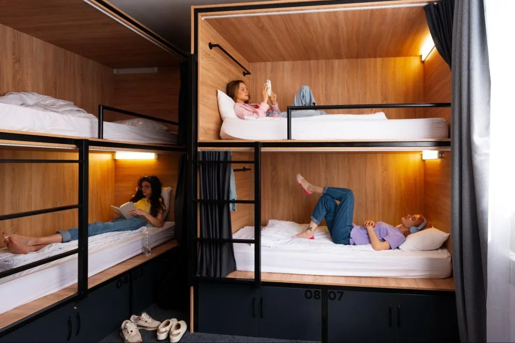 Students relaxing and reading in modern beds at Exeter student accommodation, highlighting the balance of privacy and community living