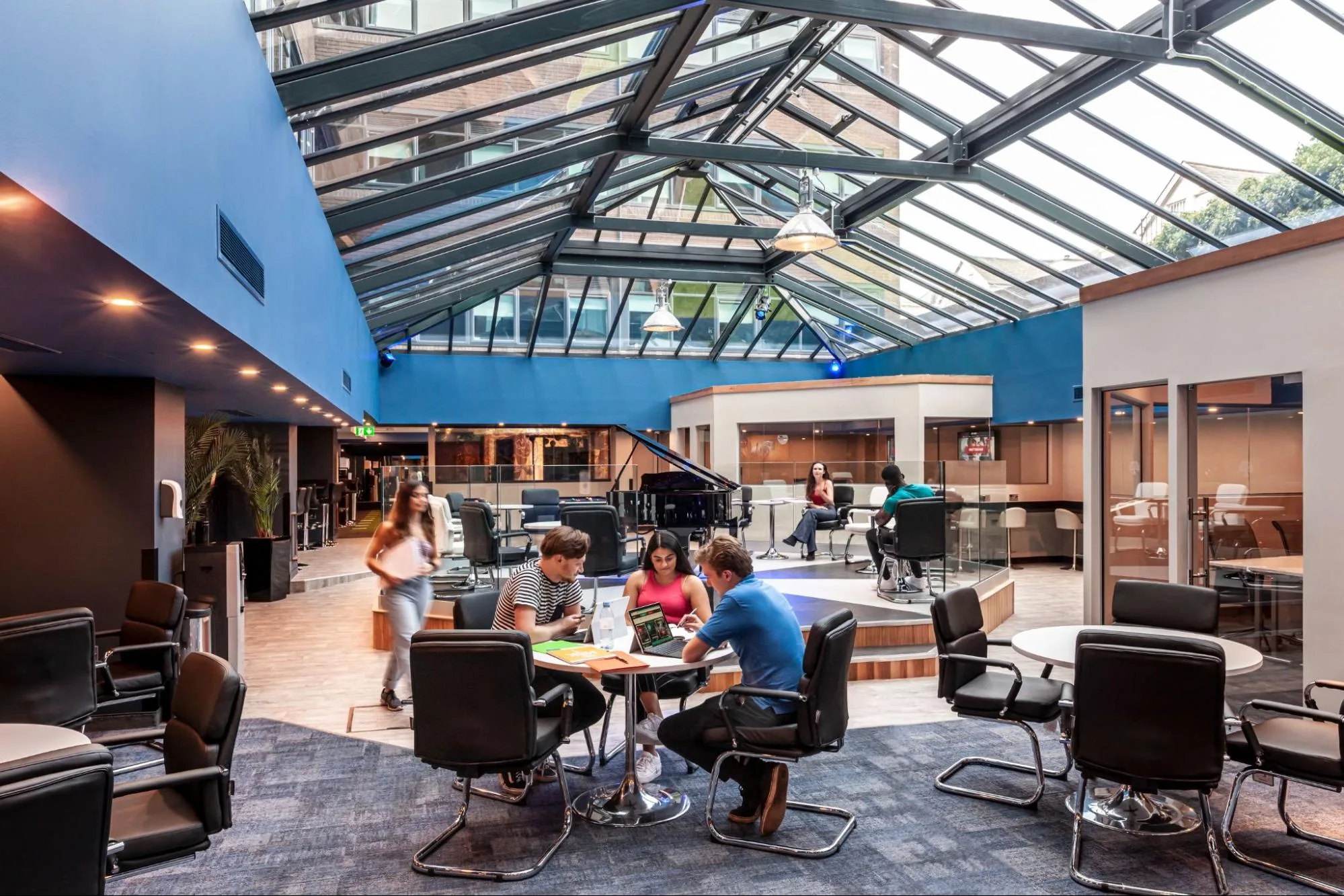 Students studying and socialising in the vibrant communal hall at Student Accommodation in Nottingham at Study Inn