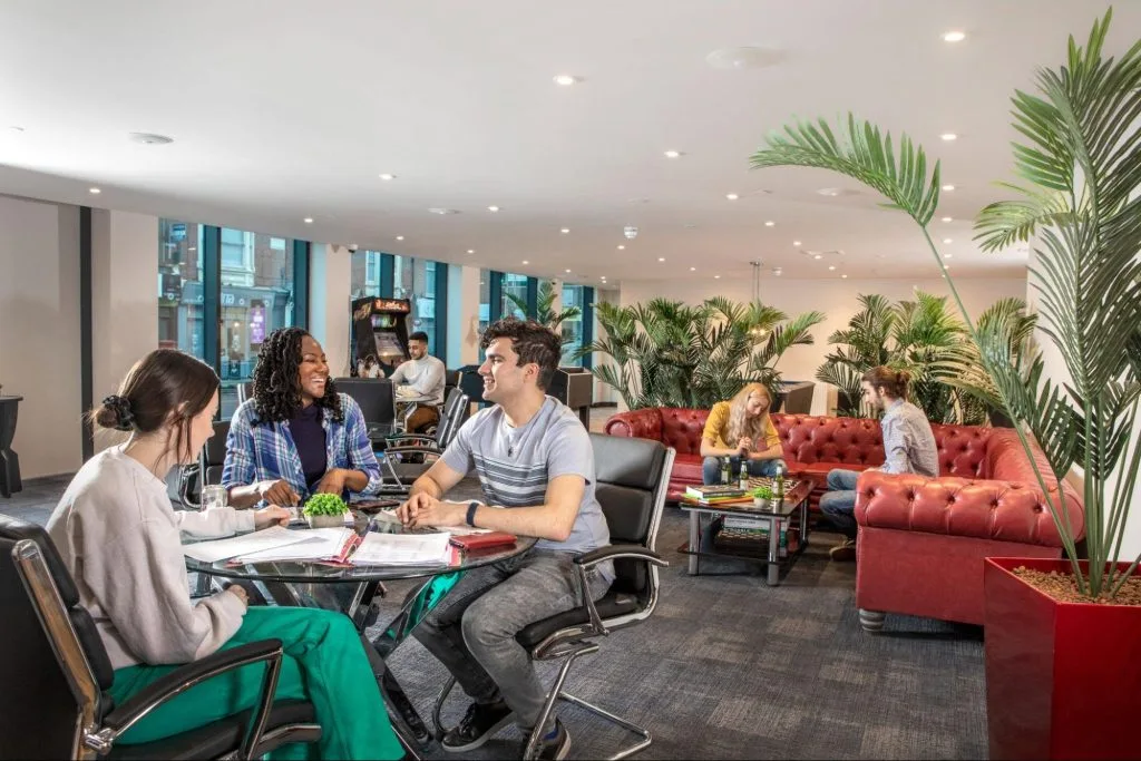 Group of students socialising in the seating area at Study Inn Leicester student accommodation, Reynard House