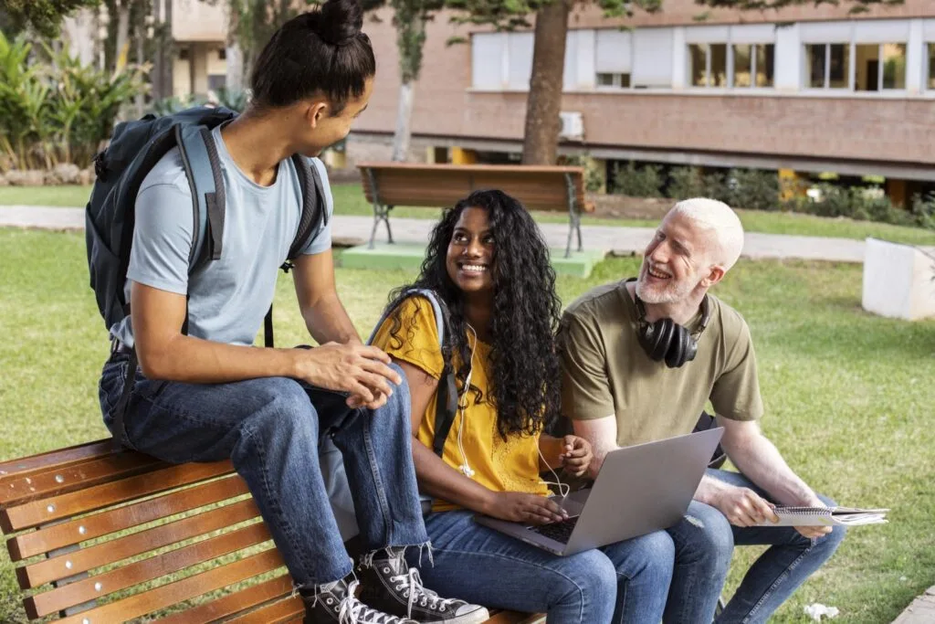 Students relaxing and chatting together outdoors on campus