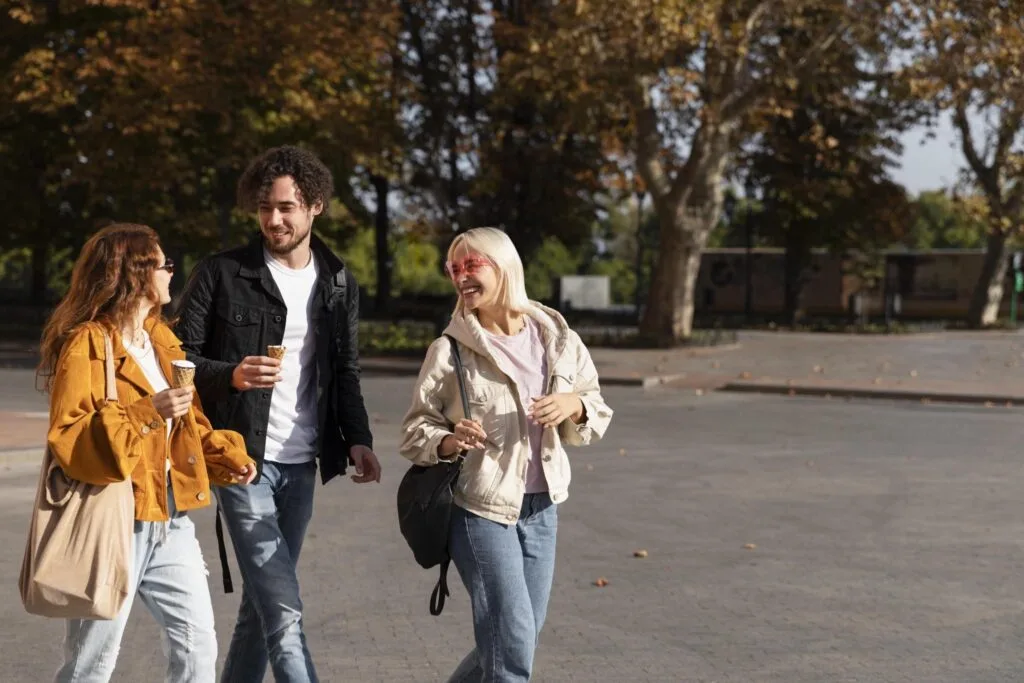 Students walking along a tree-lined street in Leeds