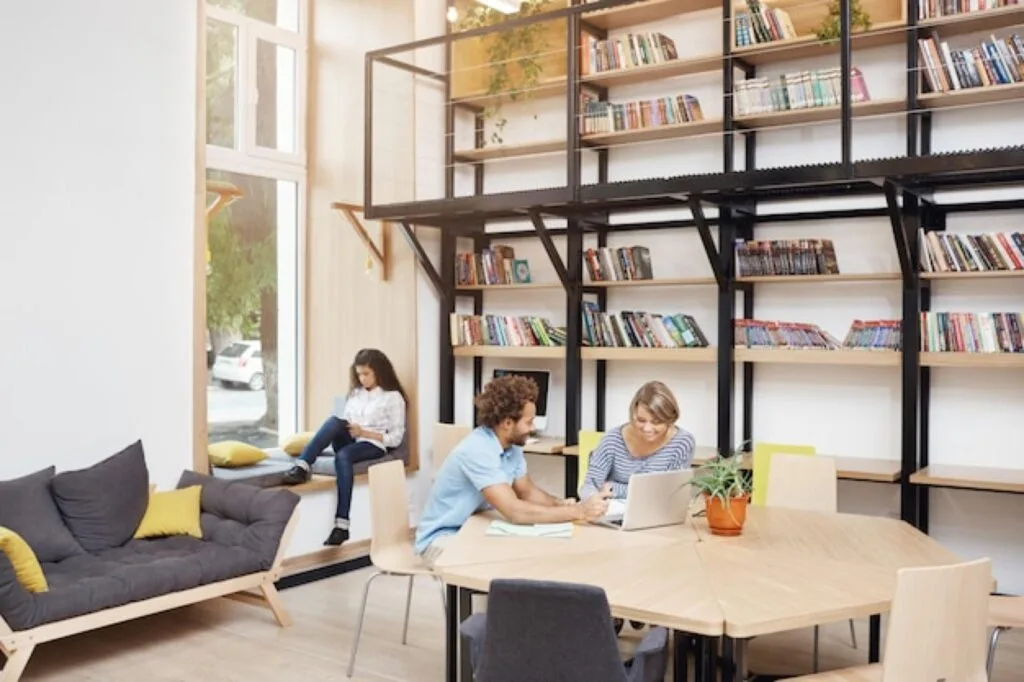 Students working at a table in a bright study space