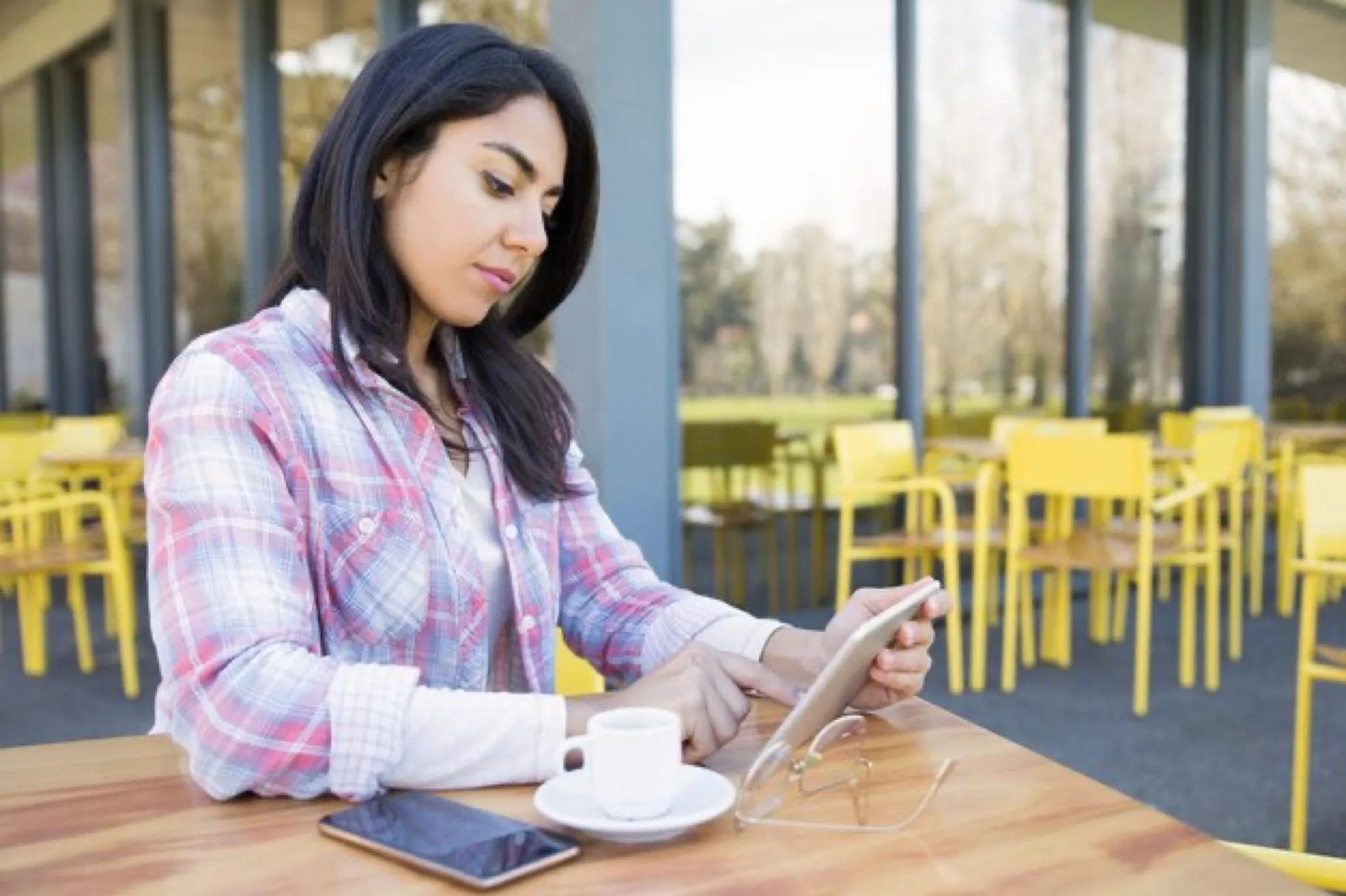 Student studying with a tablet in a quiet study space in Leicester