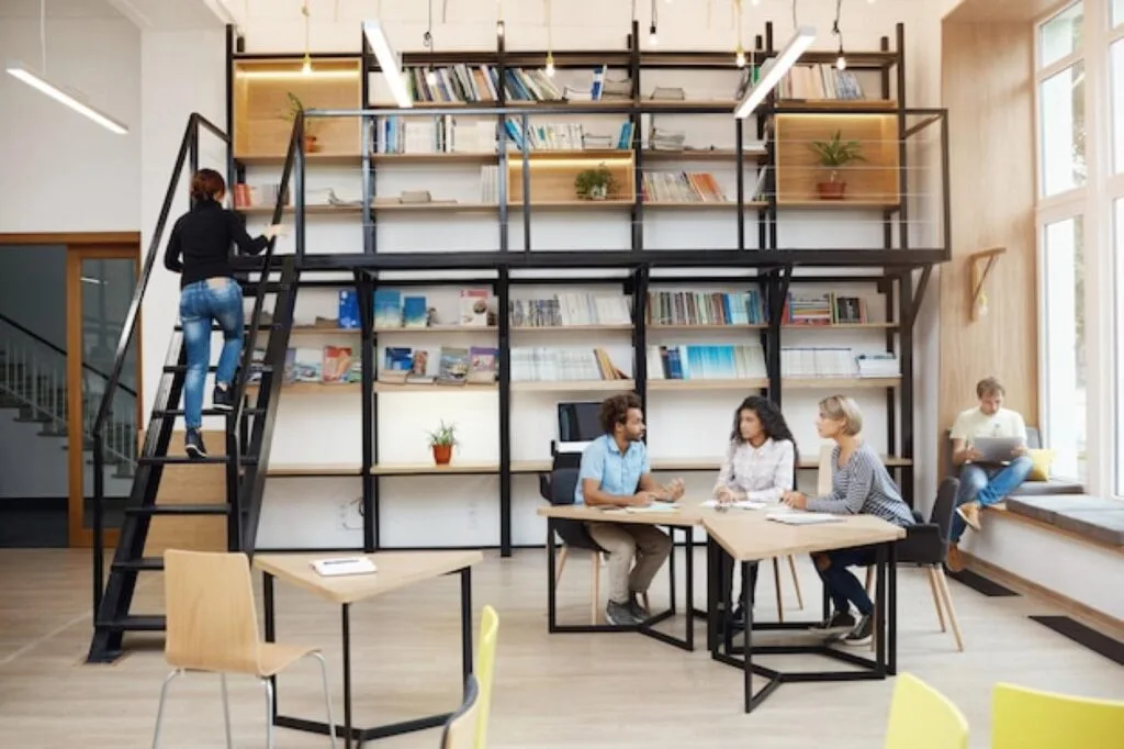 Students working at tables in a modern university library
