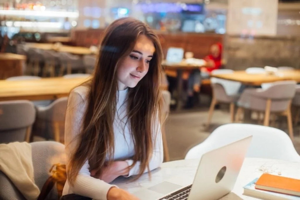 Student working on a laptop in a cafe in Nottingham