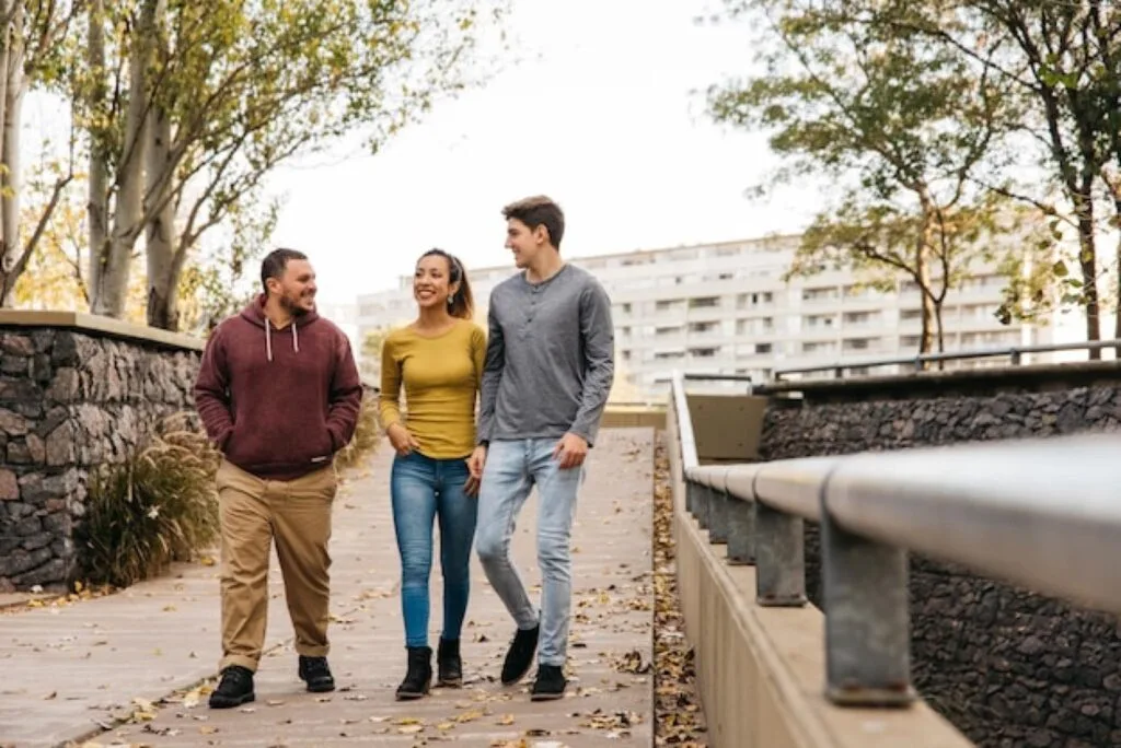 Students walking together along a tree-lined path in Birmingham
