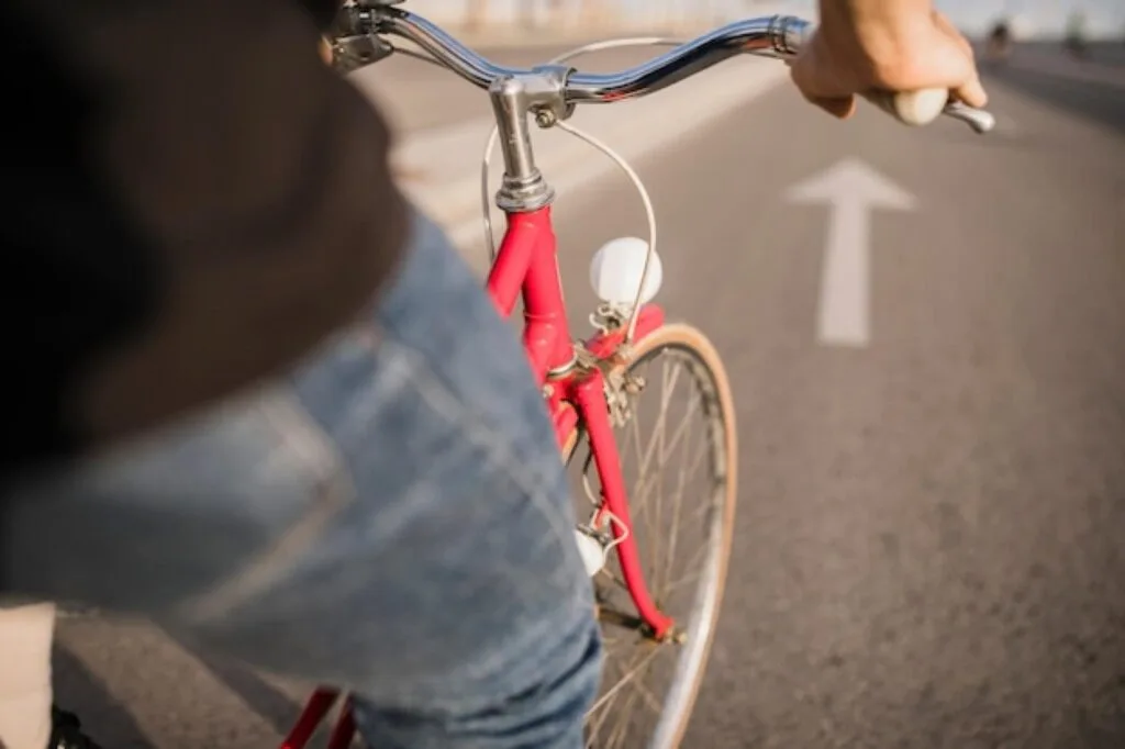 Student cycling along a marked cycle lane