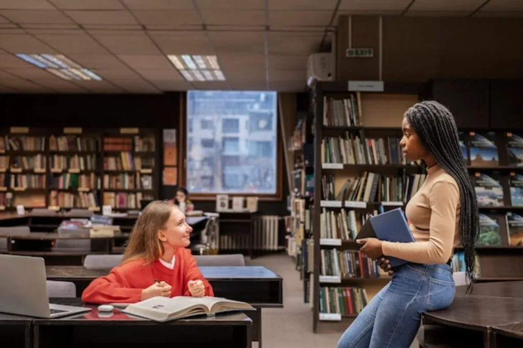 Students studying at desks in a university library