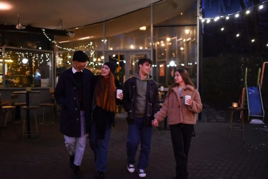Students walking home together at night in a well-lit area
