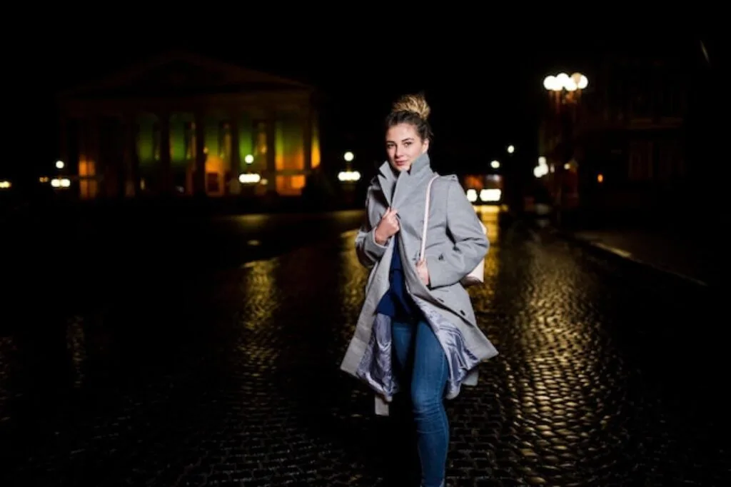 Student walking home at night along a well-lit street