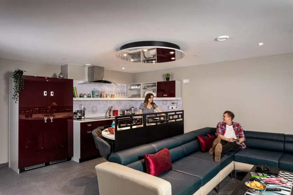 Students in a shared kitchen and lounge in student accommodation