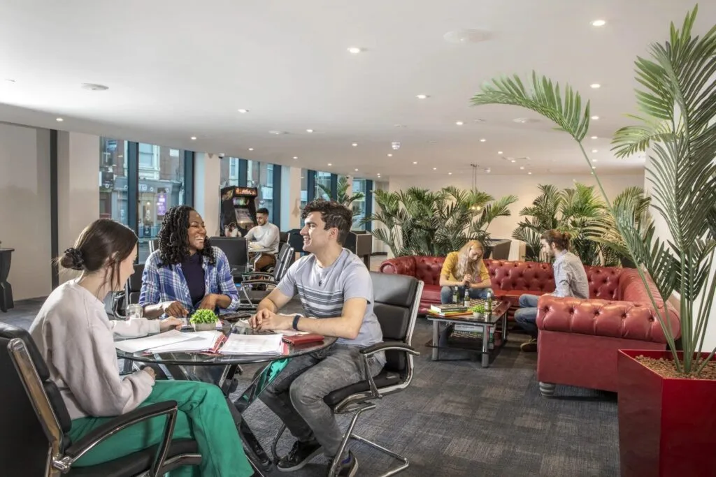 A shared social and study space at Study Inn with seating and games