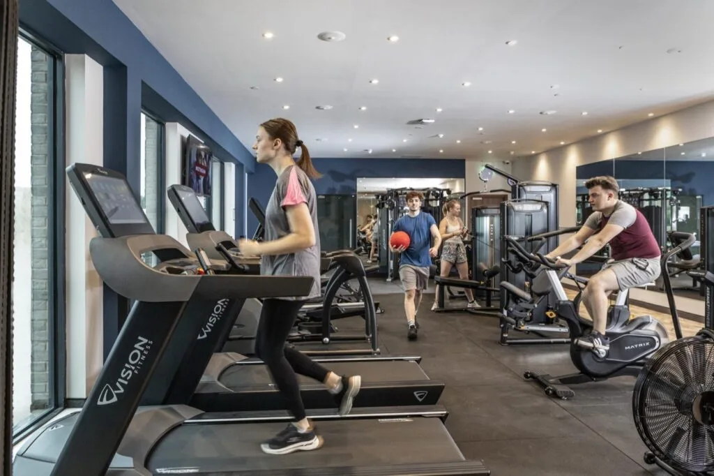 Residents using the treadmills and exercise bikes in the gym at Study Inn Triumph House, Nottingham